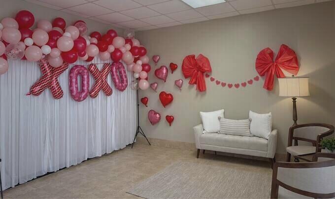 Styled photo backdrop with balloon garland at the Simply Social photography area in Hickory NC